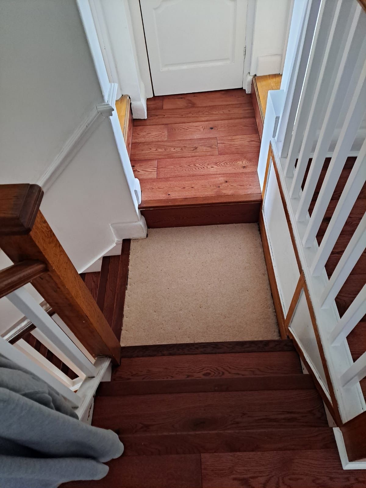 Oak stair and landing with white balustrade.